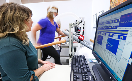From left, exercise physiologist Grace McDonald, study participant Sally Morgan, and exercise physiologist Megan Reaves during Morgan's clinical exercise test at the Duke Center for Living.