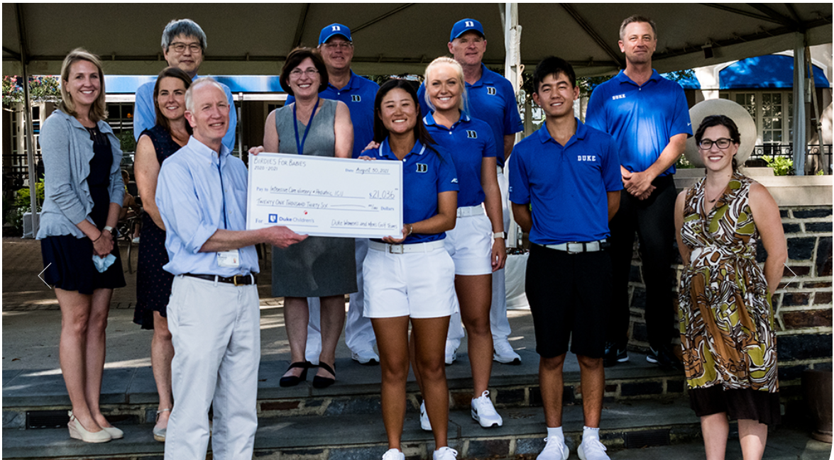 members of men's and women's golf team receiving a check from donors