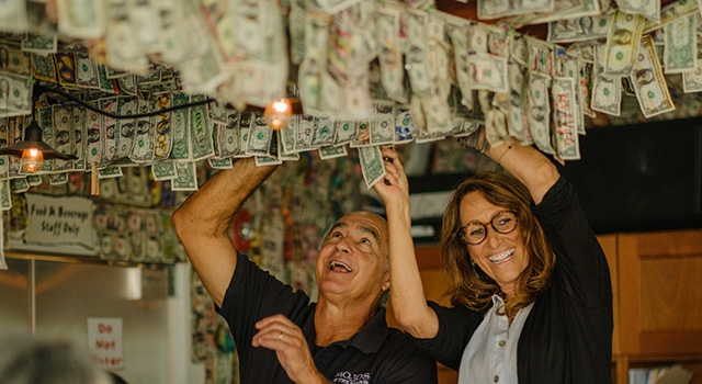 John and Andrea take the dollar bills down to donate them to pancreatic cancer research at Duke.