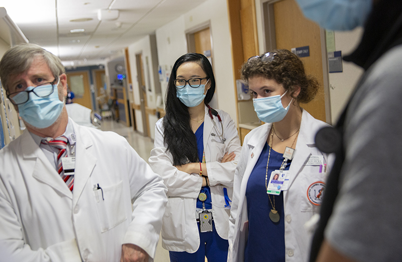 Fourth-year MSTP student Amy Petty, center, rounds with Richard Drew, PharmD, MS, and Madison Hicks at Duke University Hospital. Photo by Shawn Rocco.