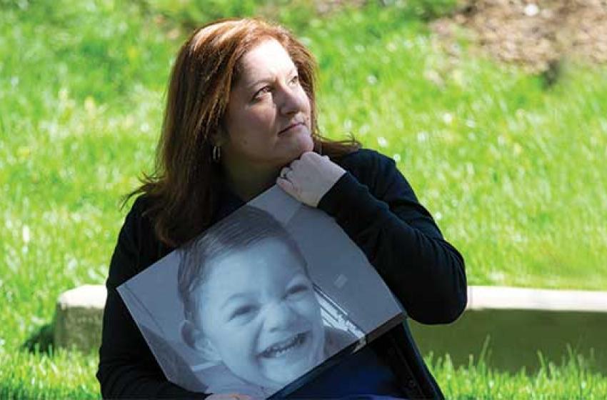 Stacy Sorenson holds a photo of her son Ryan, who passed away in 2016.
