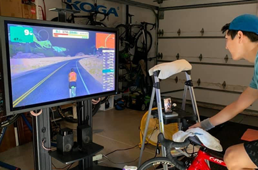 Justin Koga, a senior political science, history, and statistics student, rides virtually at his home in Irvine, California.