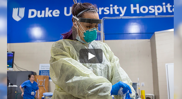 Video still of nurse at Duke Hospital wearing protective gear