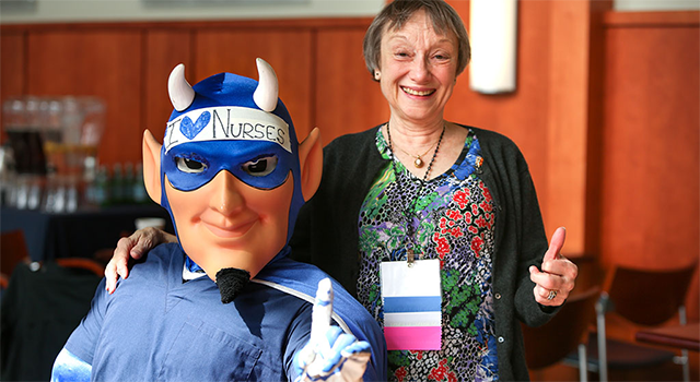 A member of the Duke Nursing Alumni Council with the Duke Blue Devil mascot