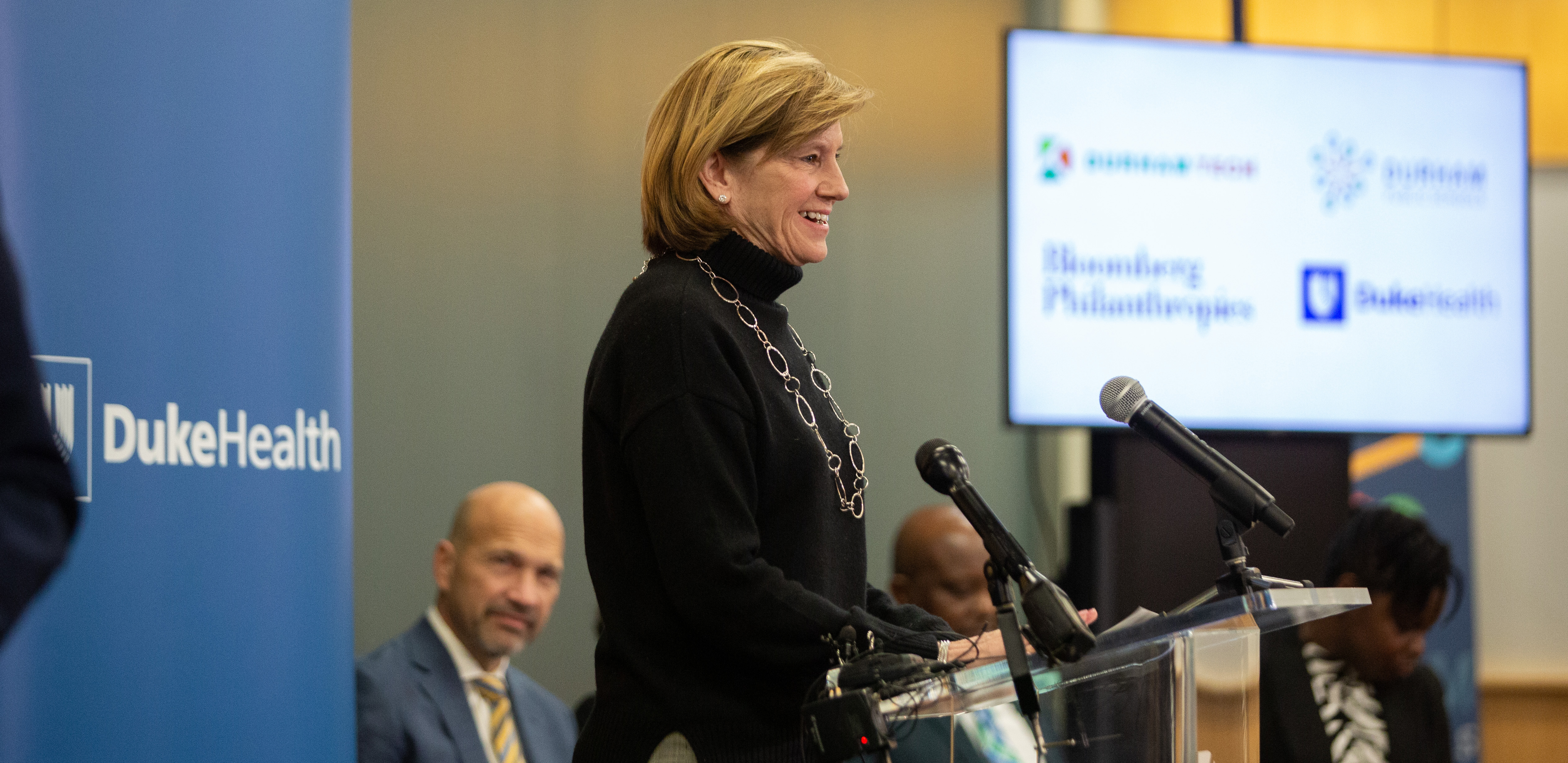 Mary E Klotman, MD, Executive Vice President for Health Affairs, Duke University, Dean, Duke University School of Medicine; and Chief Academic Officer, Duke Health speaking at the event with Craig Albanese, chief executive officer of Duke University Health System looks on. 