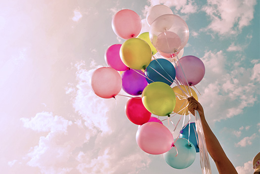 Celebrate: colorful balloons being raised into the sky