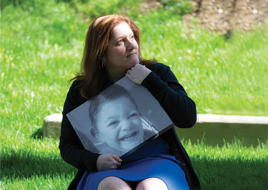 Stacy Sorensen holds a photo of her son Ryan, who passed away in 2016. Stacy now works part time with the Duke Children's Complex Care Service in honor of Ryan's memory.