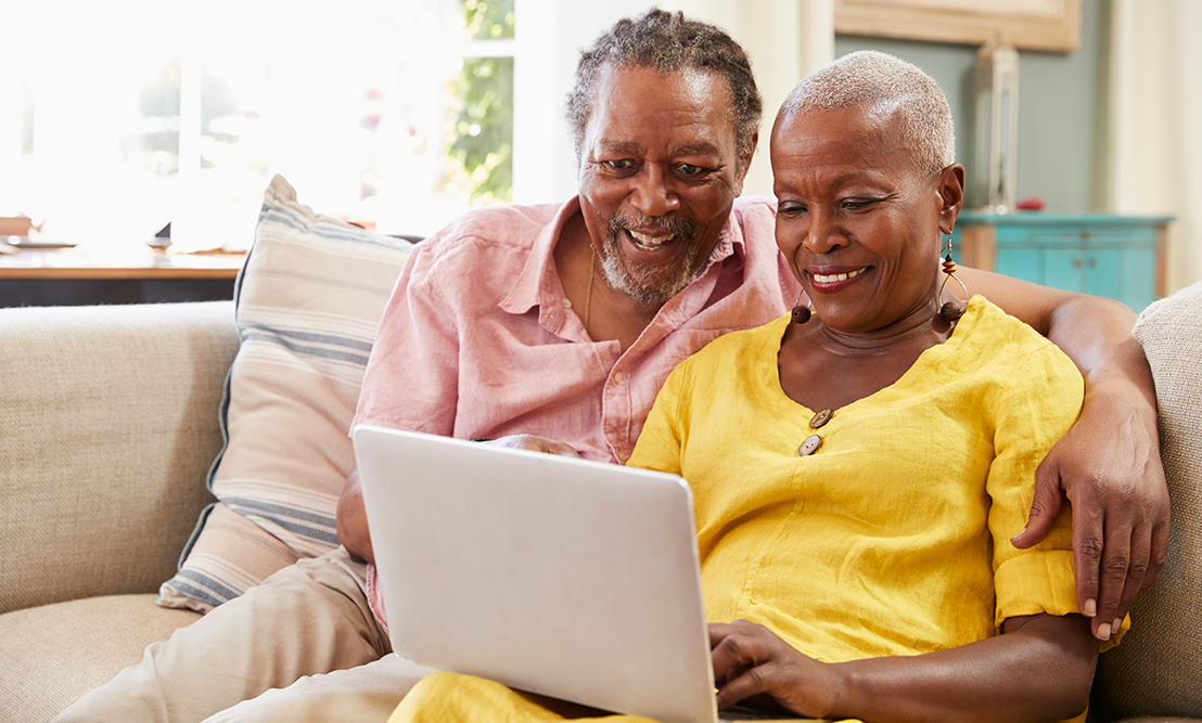 Elderly couple looking at laptop