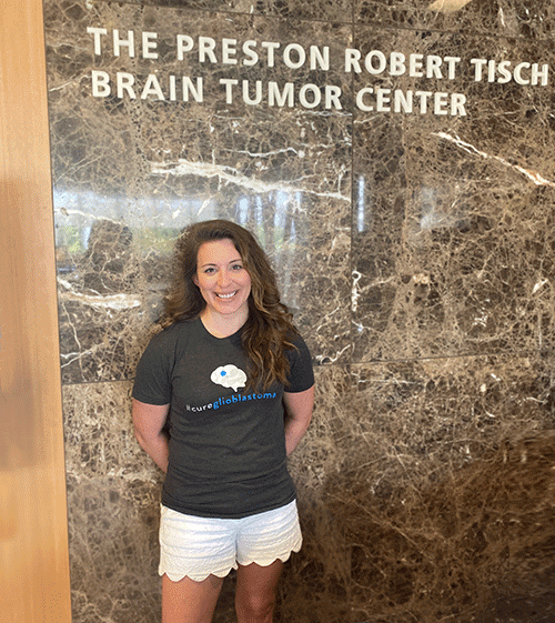 Nicole McGuinness in front of the sign reading The Preston Robert Tisch Brain Tumor Center