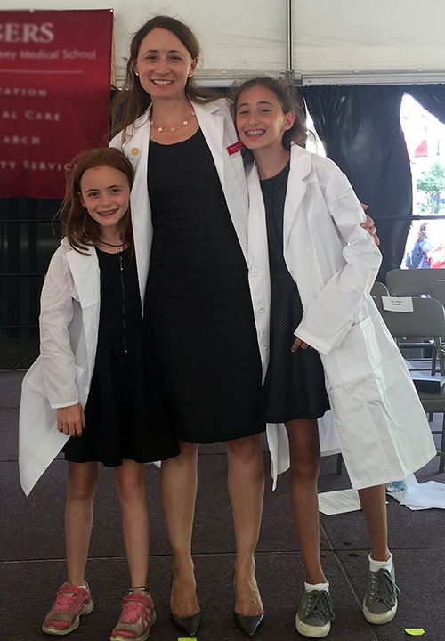Melissa Neumann at her White Coat Ceremony with her daughters, Eva and Lita Crichton.