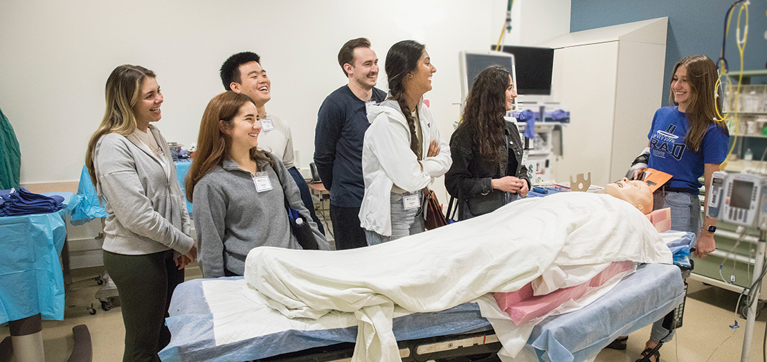 Duke School of Medicine student Brooke Schroeder explains the use of a mannequin in the simulation lab.