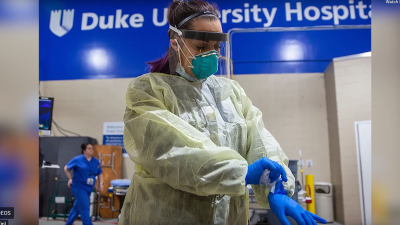 healthcare professional donning PPE during at Duke University Hospital