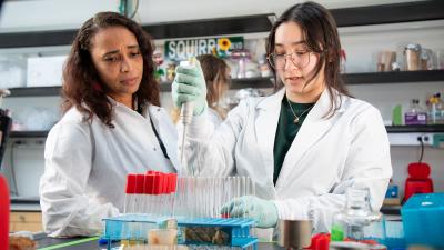Asiya Gusa, PhD, in her lab with a researcher
