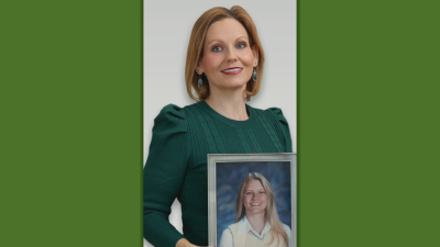 Jamie Cooper Moales holding a portrait of her sister Sara Elizabeth Cooper