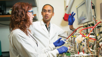 Lawrence David, PhD in his lab speaking with a lab associate