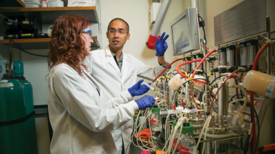 Lawrence David, PhD in his lab speaking with a lab associate