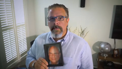 Sam Polley with a photo of his father Neill