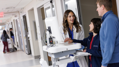 Mara Serbanescu, MD, consulting with staff in clinic.