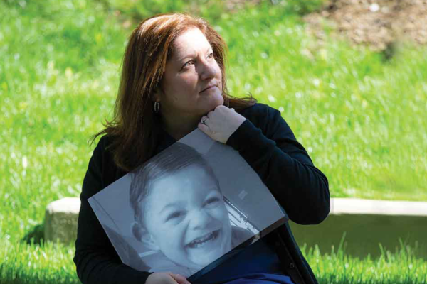 Stacy Sorensen holds a photo of her son Ryan, who passed away.