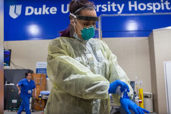 healthcare professional donning PPE during at Duke University Hospital