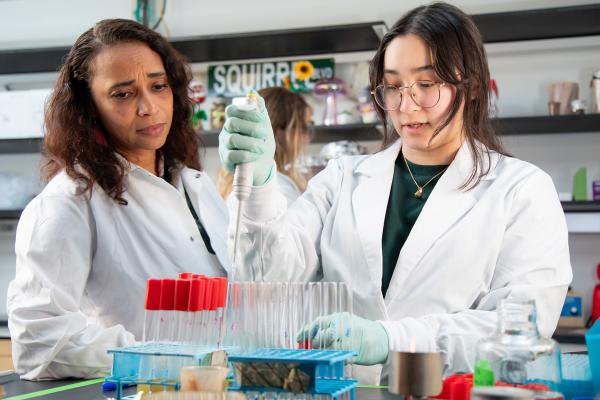 Asiya Gusa, PhD, in her lab with a researcher