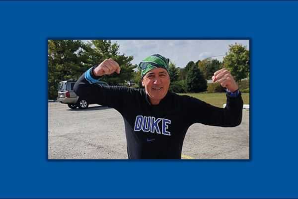John Harkey posing with arms flexed
