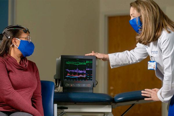 physician performing a brain scan on a patient.