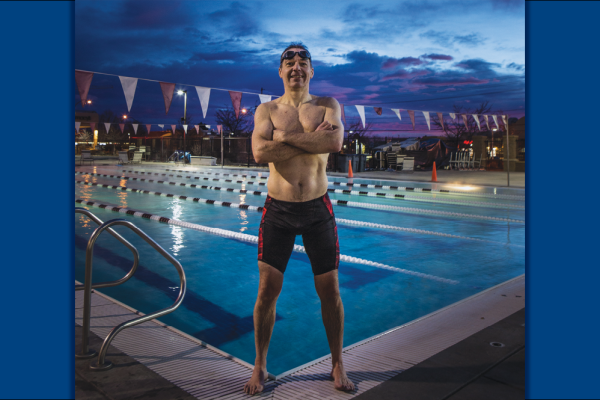 Gavin Maitland poses by a pool in his swimsuit