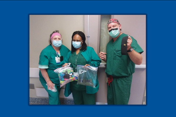Nurses holding gifts from the community
