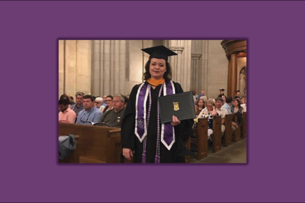 Samantha Casper in a cap and gown holding a diploma