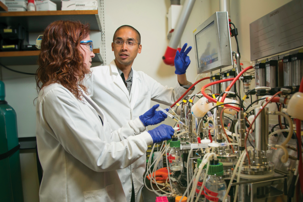 Lawrence David, PhD in his lab speaking with a lab associate