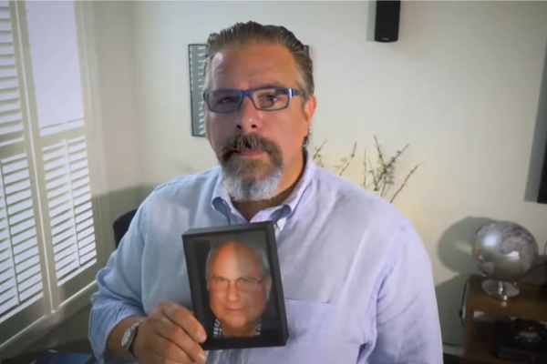 Sam Polley with a photo of his father Neill