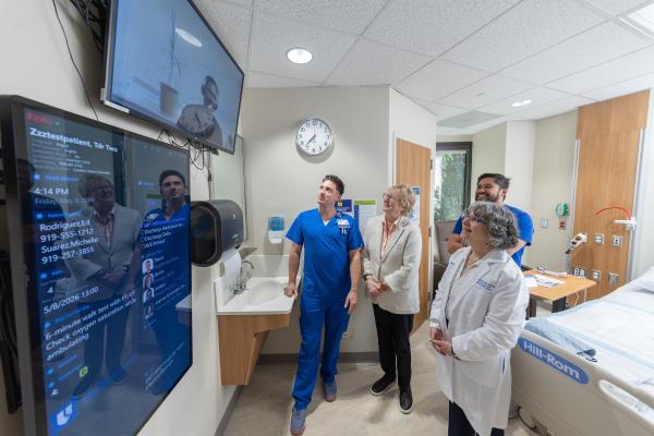 Nancy Schlichting and Terry McDonnell talk with several nurses.