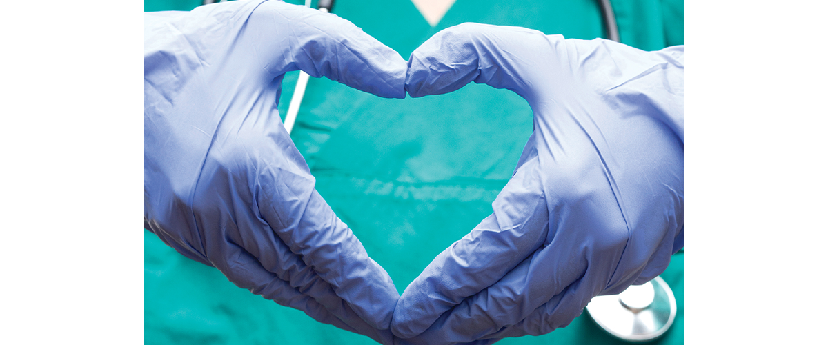 gloved hands making the shape of a heart