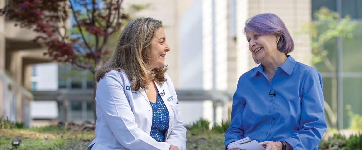 provider and aging patient talking together outside in the garden