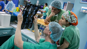 Duke surgeon Adam R. Williams examines chest x-rays with Honduran surgeon Hugo Orellana and Marysol Valeriano, MD.
