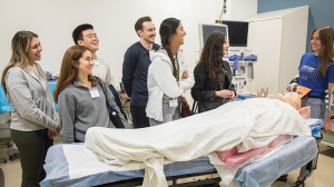 Brooke Schroeder explains the use of a mannequin in the simulation lab.