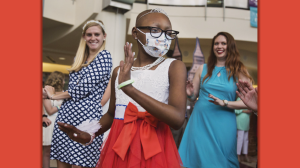 Young masked cancer patient dancing in the Duke Hospital Atrium