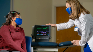 physician performing a brain scan on a patient.