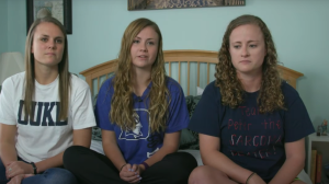 Peter Morrisette's three young adult daughters sitting together on a bed
