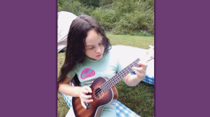 zoe petko playing a small guitar