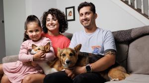 Iris Bugbee, MS, CCC-SLP, with her husband Greg, daughter Mila, and corgis, Candi and Charli, at her home