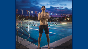 Gavin Maitland poses by a pool in his swimsuit