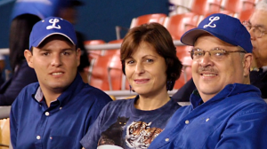 Juan Battle and his family in the stands at a baseball game. 