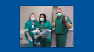 Nurses holding gifts from the community