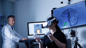 Dr. Feng in his lab with a patient wearing VR Glasses