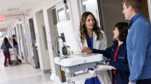 Mara Serbanescu, MD, consulting with staff in clinic.