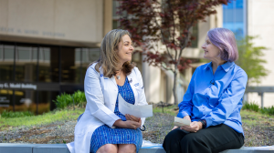 Heather Whitson, MD, speaking with an older patient