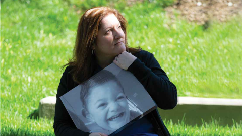Stacy Sorensen holds a photo of her son Ryan, who passed away.