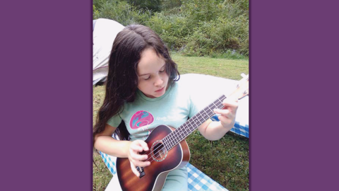 zoe petko playing a small guitar